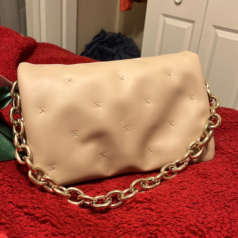 Intrinsic woman’s hand bag.  NWOT.  Snap closure, gold chain. Expandable.